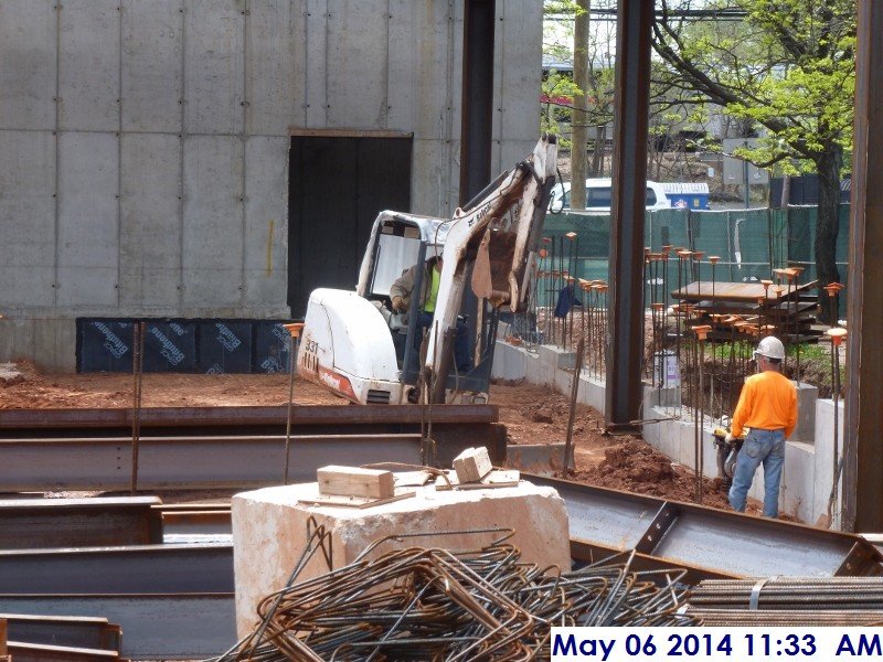 Backfilling and compacting along foundation walls at column line A (1.6-4)